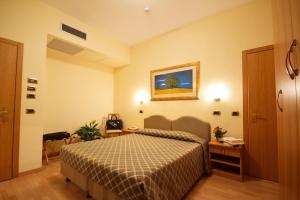 Postel nebo postele na pokoji v ubytování Hotel Villa Luca