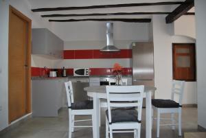 a kitchen with a white table and chairs at Apartamento Tramuntana in Perelló