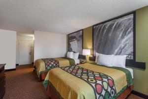 a hotel room with two beds and a tv at SuperB Hamburg Motel in Hamburg