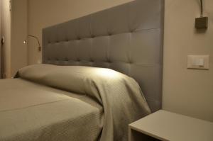 a bedroom with a bed with a large headboard at Villa Bonin in Zovencedo