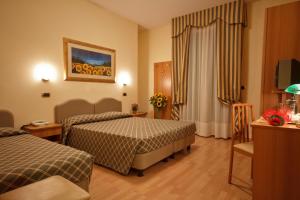 Postel nebo postele na pokoji v ubytování Hotel Villa Luca