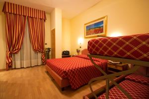 Postel nebo postele na pokoji v ubytování Hotel Villa Luca