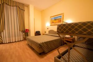 Postel nebo postele na pokoji v ubytování Hotel Villa Luca