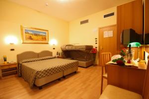 Postel nebo postele na pokoji v ubytování Hotel Villa Luca