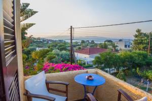 a patio with a table and chairs on a balcony at Vagia Traditional, Aegina Island in Vaia