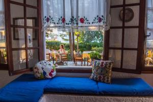 a room with a blue couch in front of a window at Vagia Traditional, Aegina Island in Vaia