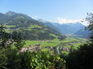 a village in a valley with mountains in the background at Neurauthof in Zellberg
