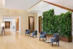 a lobby with chairs and a large green wall at The Westin Cairo Golf Resort & Spa, Katameya Dunes in Cairo