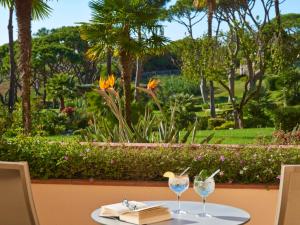 a table with two wine glasses on top of it at Hotel Quinta do Lago in Quinta do Lago