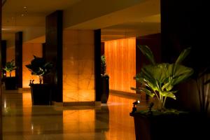 a lobby with potted plants in a building at Sheraton Miyako Hotel Osaka in Osaka