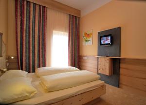 Posteľ alebo postele v izbe v ubytovaní Thermenhotel PuchasPLUS Stegersbach