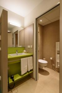 a bathroom with a sink and a toilet at Hotel Cloppenburg in Cloppenburg