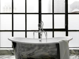 a white sink sitting in front of a window at The Whitby Hotel in New York