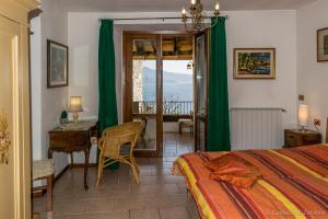 a bedroom with a bed and a table and a desk at Castello di Zorzino Iseo lake in Riva di Solto