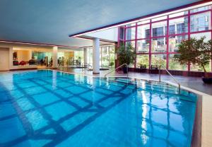 a large pool with blue water in a building at Embarc Vancouver in Vancouver