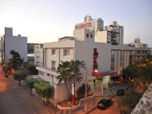 a white building with a sign on top of it at Hotel Plenotel in Collatina