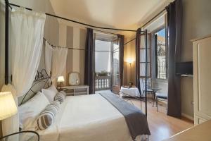 a bedroom with a large bed and a large window at B&B Di Piazza Del Duomo in Florence