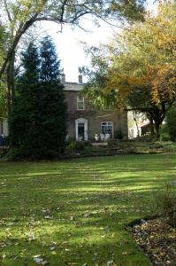 a house with a large yard with green grass at Healey House Hotel in Batley