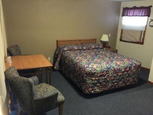 Giường trong phòng chung tại Welch Motel