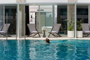 a person swimming in a swimming pool at INNSiDE by Meliá Palma Bosque in Palma de Mallorca