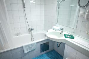 a bathroom with a sink, toilet, and bathtub at Doktorschlössl in Salzburg