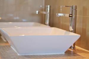 a white bath tub with a faucet in a bathroom at Apartments Villa Milna 1 in Budva