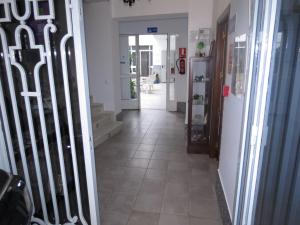 pasillo con suelo de baldosa y puerta de hierro forjado en Pensión Guerrero, en Cabra