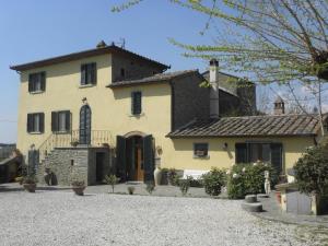 a large yellow house with black shutters at Villa San marco in Cortona