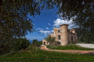 an old building with a tower on a hill at Donna Giulia in Caprioli