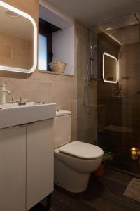 a bathroom with a toilet and a sink and a shower at Apartment Pearl of Cabrils in Cabrils