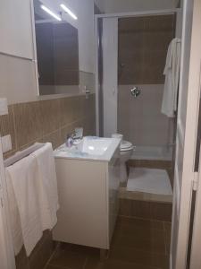 a white bathroom with a sink and a toilet at Casa Anna Maria in Marsala +40 photos