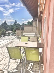 a patio with a table and chairs on a balcony at Apartment Marija in Selce
