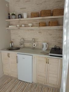 a kitchen with a sink and a counter top at Holiday Home Kolka in Kolka