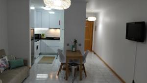 a small living room with a table and a couch at Workspace.job in Portimão