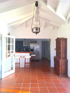 een keuken met een tafel en stoelen en een kroonluchter bij Aloe Villa in Five Islands Village