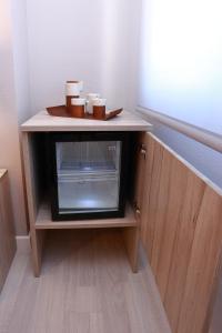 a small cabinet with a microwave in a room at Hotel Villa de Verín in Verín