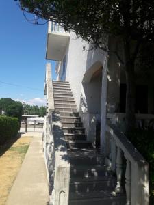 una scala che porta a un edificio bianco di Apartment Zdenka a Povljana (Pogliana)