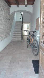 a bike parked in a room with a staircase at City Apartment Goga in Pula