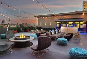 a patio with furniture and a fire pit on a roof at Revere Hotel Boston Common in Boston