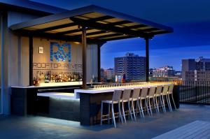 a bar on the roof of a building with chairs at Revere Hotel Boston Common in Boston