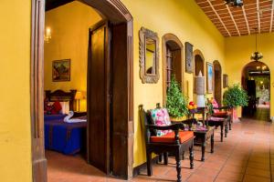 
a room with a table, chairs, and tables in it at Hotel Casa Antigua by AHS in Antigua Guatemala
