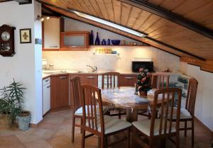 a kitchen with a table and chairs in a room at Apartment MaLa in Bled