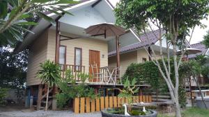 a small house with an umbrella in front of it at Bansuan Inthanon Resort in Chom Thong