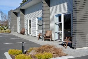 a group of chairs sitting outside of a building at Oxford Village Motels in Oxford