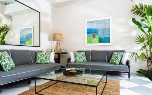 a living room with two couches and a table at Villa Alliv in Seminyak