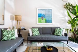 a living room with two couches and a glass table at Villa Alliv in Seminyak +25 photos