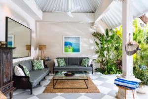 a living room with a couch and a table at Villa Alliv in Seminyak