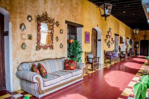 a living room with a couch in the middle of a room at Hotel Convento Santa Catalina by AHS in Antigua Guatemala
