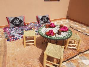 a room with a table and chairs and a bed at Dar Amadine in Imlil