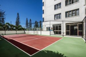 a tennis court with a tennis racket on it at Pacific Beach Resort in Mooloolaba